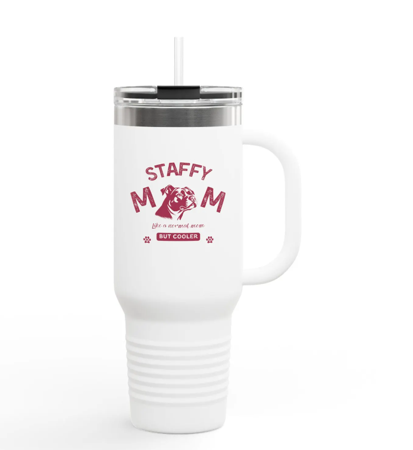 An white, insulated thermos with a straw. There's a design in red that says Staffy mom. Just like a regular mom but normal.